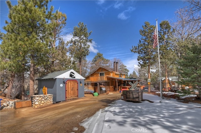 view of front of house with an outbuilding and a shed