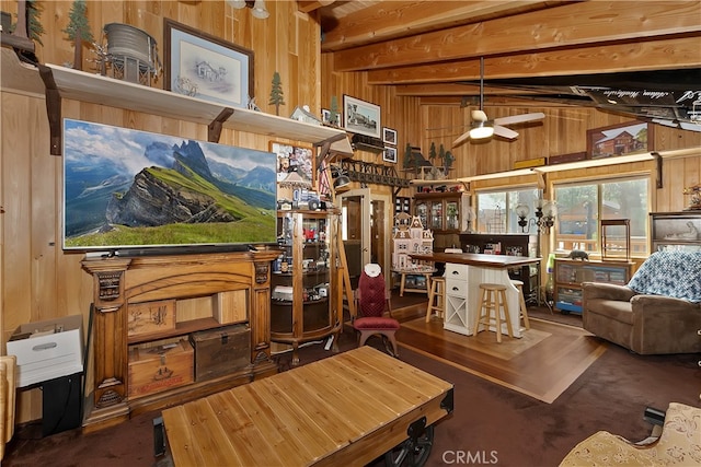 interior space featuring lofted ceiling with beams, wood walls, and ceiling fan