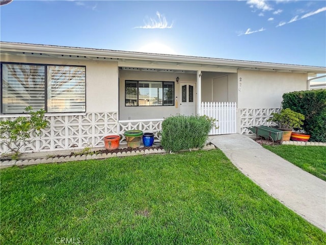 view of front of property with a front lawn and stucco siding