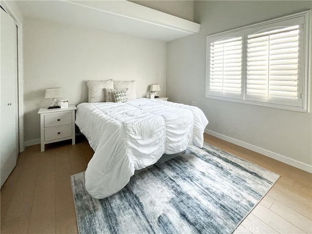 bedroom featuring baseboards and wood finished floors