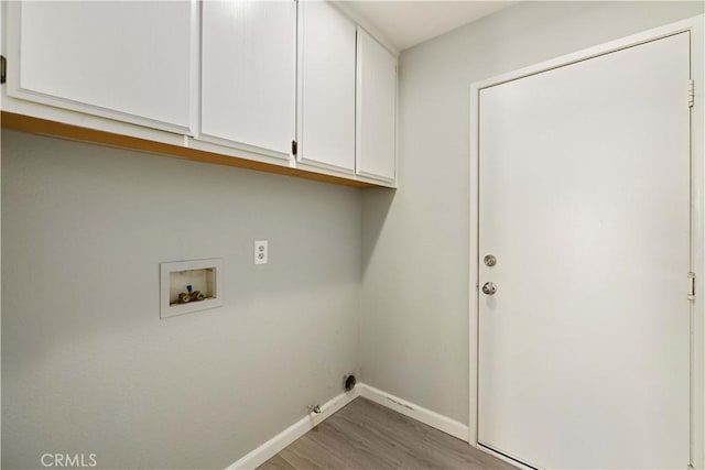 laundry area with wood finished floors, cabinet space, baseboards, gas dryer hookup, and hookup for a washing machine