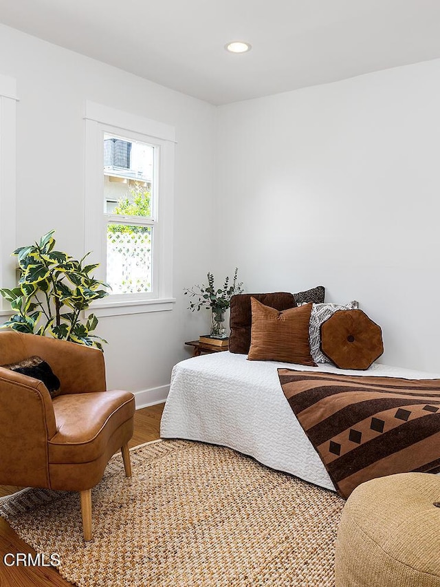 bedroom with recessed lighting, baseboards, and wood finished floors