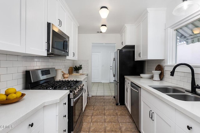 kitchen featuring a sink, white cabinetry, and stainless steel appliances