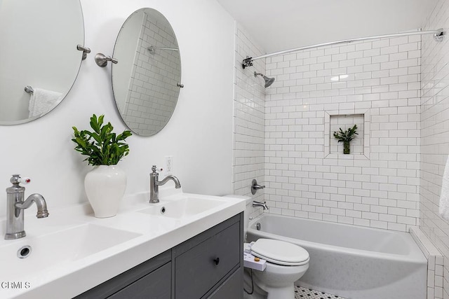 bathroom featuring a sink, toilet, double vanity, and washtub / shower combination