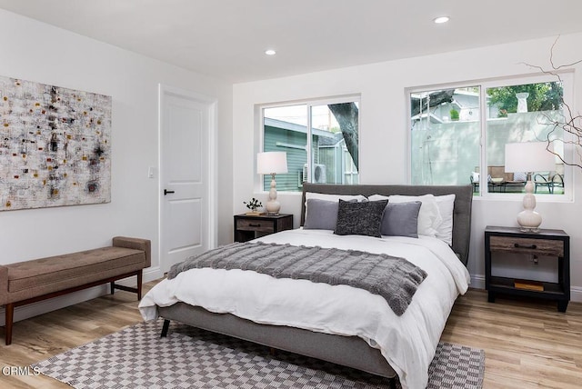 bedroom featuring recessed lighting, baseboards, and light wood finished floors