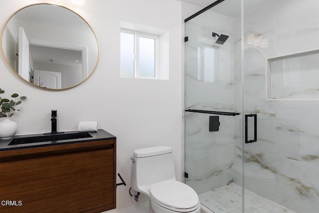 full bath with vanity, toilet, and a shower stall