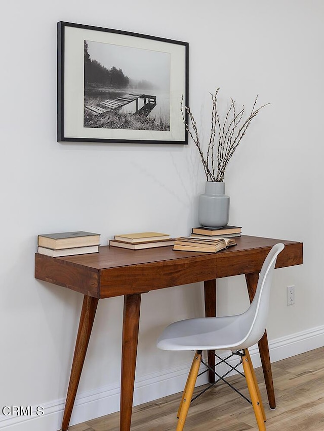 room details featuring baseboards and wood finished floors