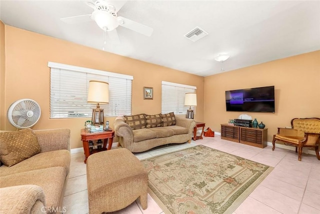 tiled living room with visible vents, baseboards, and a ceiling fan