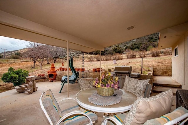 view of patio featuring outdoor dining space and a grill