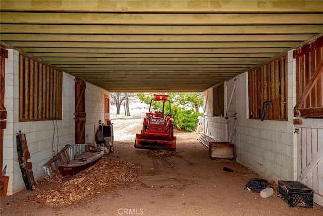 view of patio / terrace featuring an outbuilding, an attached carport, and an exterior structure