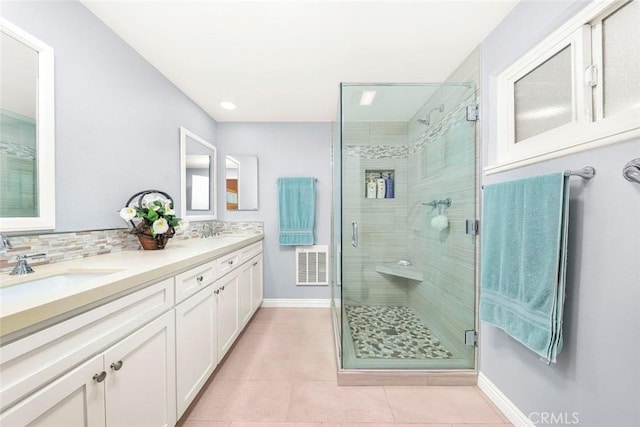 bathroom featuring a sink, visible vents, a shower stall, and tile patterned floors