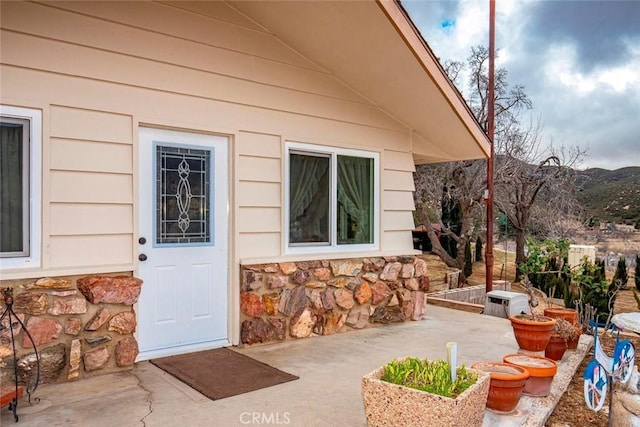 property entrance featuring stone siding