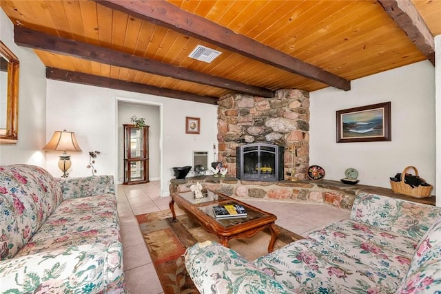 living area featuring tile patterned flooring, visible vents, beam ceiling, wooden ceiling, and a fireplace