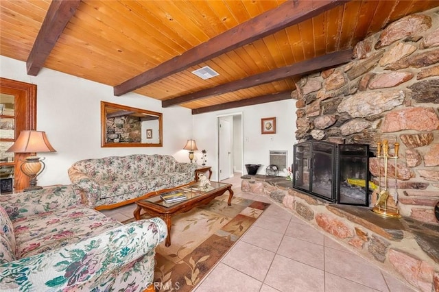 tiled living room featuring beam ceiling, visible vents, wooden ceiling, and a fireplace