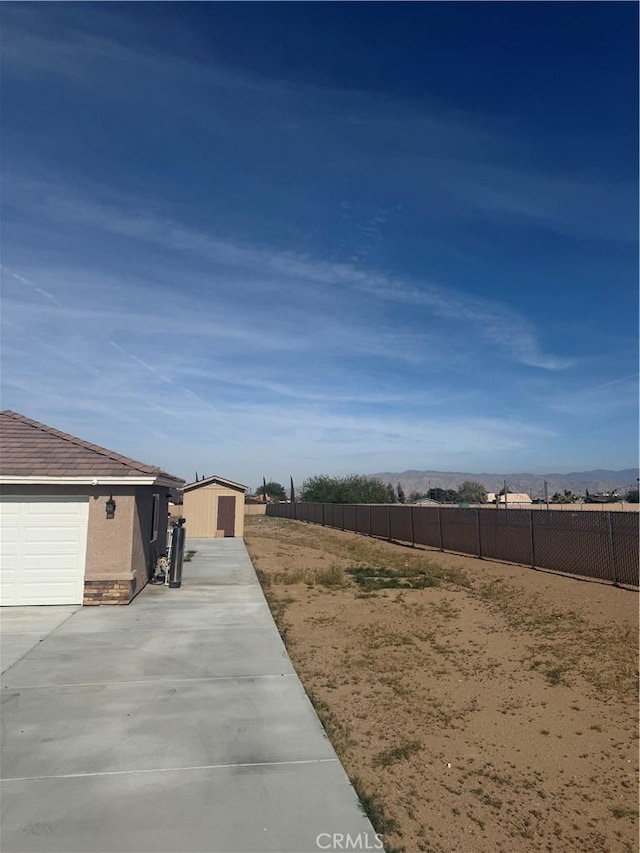 view of yard featuring fence and an outdoor structure