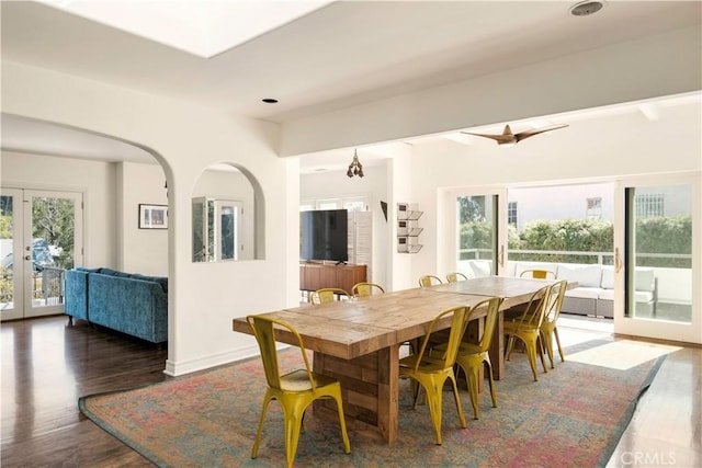 dining area featuring french doors, baseboards, and wood finished floors