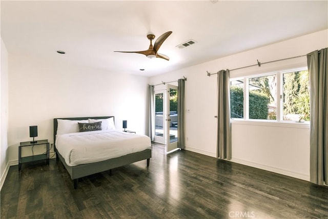 bedroom featuring visible vents, wood finished floors, baseboards, and access to outside