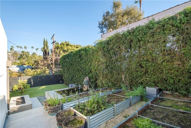 view of yard with a vegetable garden and fence