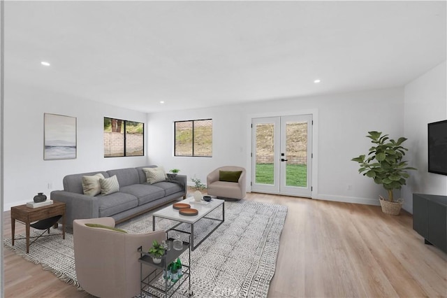 living room featuring recessed lighting, french doors, light wood-type flooring, and baseboards