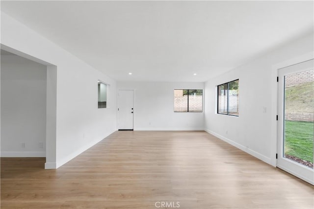 empty room with recessed lighting, baseboards, and light wood-style flooring