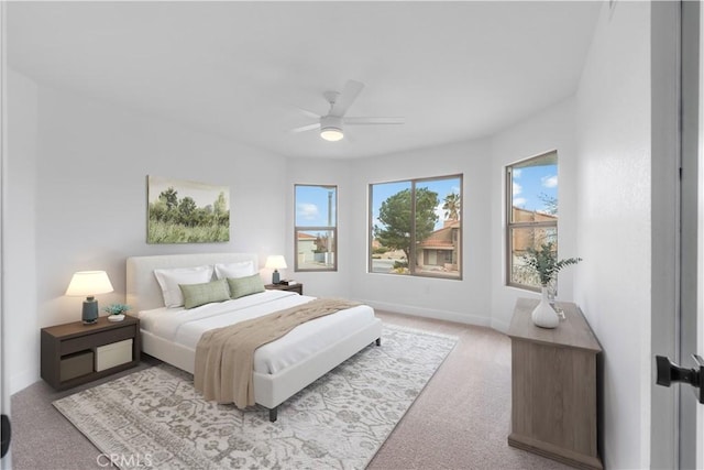 carpeted bedroom featuring a ceiling fan and baseboards