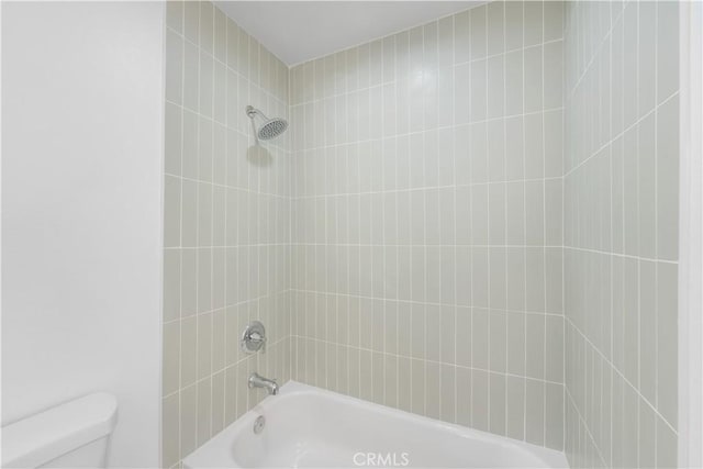 bathroom with shower / bathing tub combination and toilet