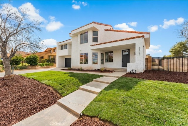 mediterranean / spanish-style house with a front lawn, fence, a tile roof, stucco siding, and a garage