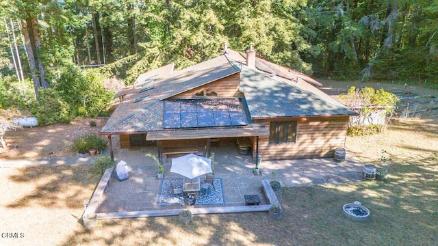 view of front of house featuring a patio area and a shingled roof