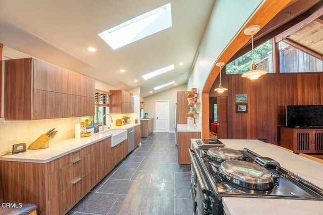 kitchen featuring a sink, lofted ceiling with skylight, modern cabinets, and light countertops