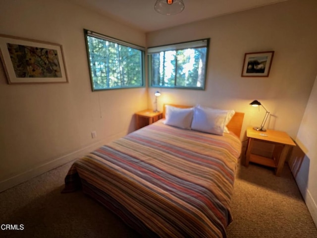 bedroom featuring carpet flooring and baseboards