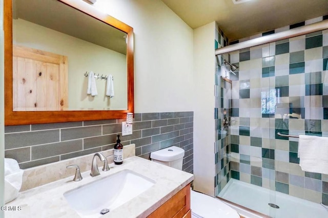 full bathroom featuring backsplash, vanity, toilet, and a shower stall