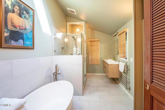 bathroom featuring a closet, visible vents, a shower stall, and vaulted ceiling