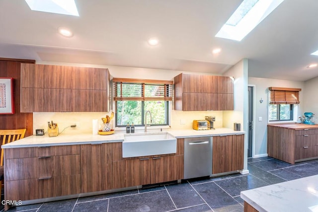 kitchen with a healthy amount of sunlight, dishwasher, modern cabinets, and a sink