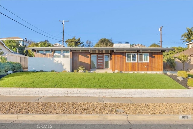 view of front of property with a front yard and fence