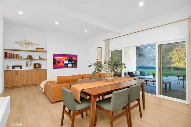 dining room featuring light wood-style flooring, recessed lighting, and beamed ceiling