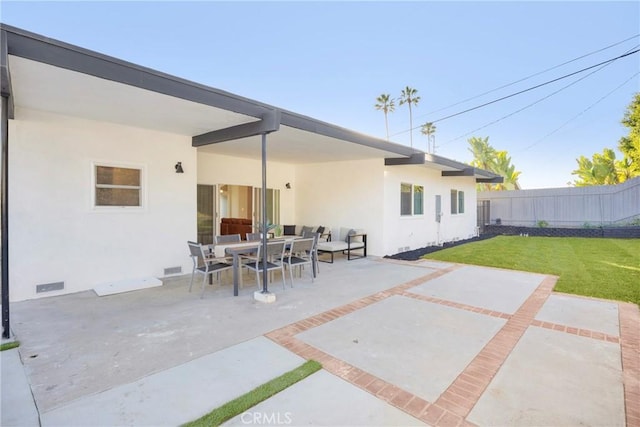 view of patio featuring visible vents, outdoor dining space, and fence