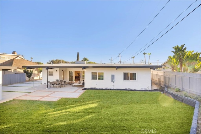 rear view of house featuring stucco siding, a fenced backyard, a yard, crawl space, and a patio