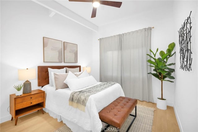 bedroom with baseboards, light wood finished floors, and ceiling fan