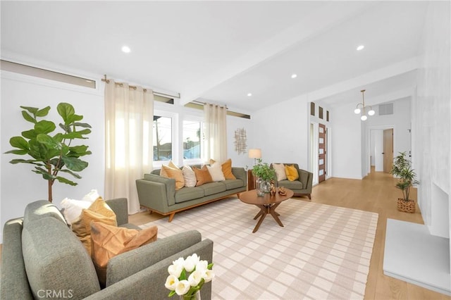 living room with vaulted ceiling with beams, recessed lighting, visible vents, and light wood finished floors