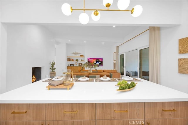 kitchen with beam ceiling, modern cabinets, and light countertops