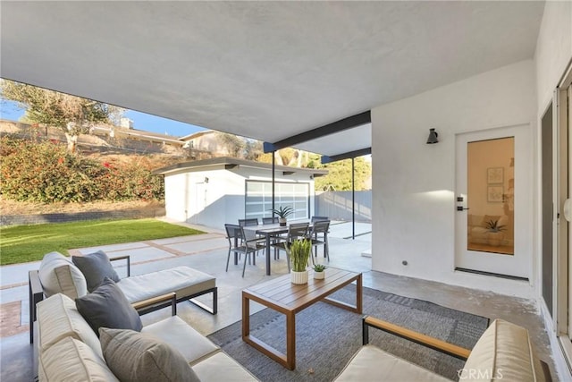 view of patio / terrace with outdoor dining area, an outbuilding, and outdoor lounge area