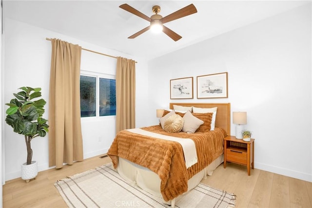 bedroom featuring visible vents, ceiling fan, light wood-type flooring, and baseboards