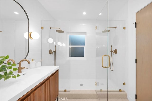 bathroom featuring a shower stall and vanity