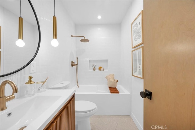 bathroom with vanity, shower / bath combination, tile patterned floors, toilet, and tile walls