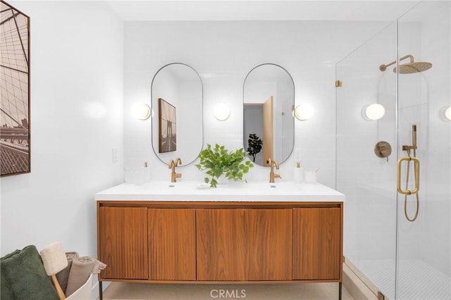 full bath featuring a shower stall, double vanity, and a sink