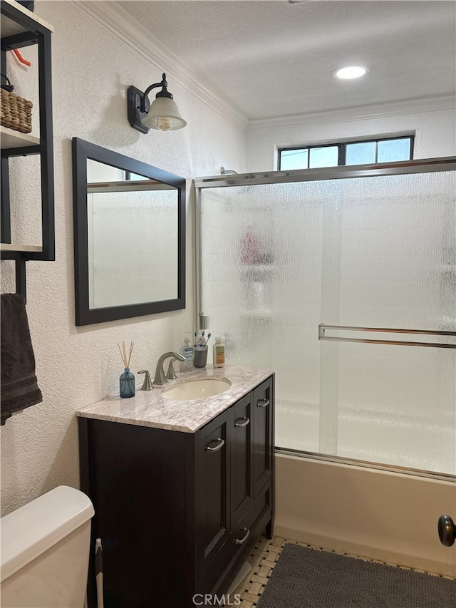 bathroom with toilet, ornamental molding, vanity, and a textured wall