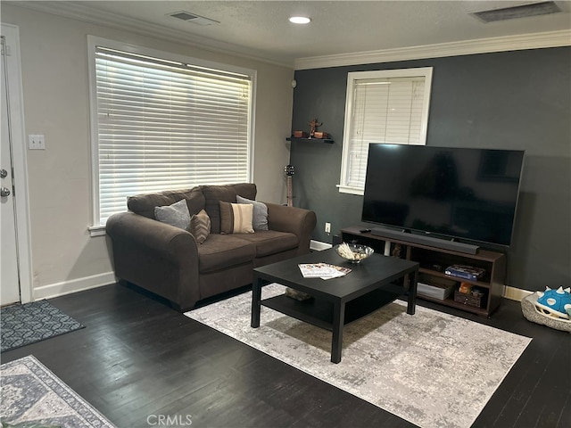 living area with visible vents, baseboards, dark wood-style floors, and ornamental molding