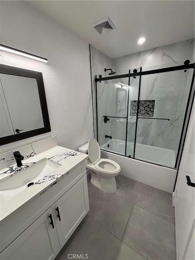 full bath featuring vanity, toilet, visible vents, and shower / bath combination with glass door