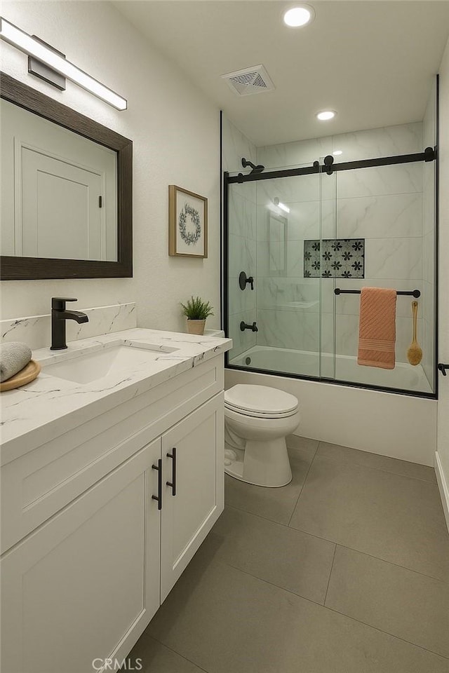 full bath with toilet, vanity, bath / shower combo with glass door, recessed lighting, and tile patterned floors