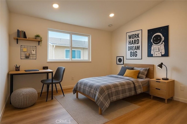 bedroom with light wood finished floors, baseboards, recessed lighting, and vaulted ceiling